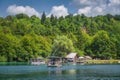 Ferry with tourists departing small harbour in Plitvice Lakes