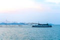 The ferry with tourists floats on the sea throwing out clouds of black smoke