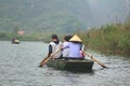 Ferrymen are taking tourists to visit the Trang An Eco-Tourism Complex, a complex beauty - landscapes called as an outdoor Royalty Free Stock Photo