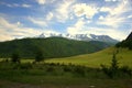 Fertile valley near the hill overlooking the mountain ranges in the snow