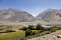 Fertile Wakhan Valley with Panj river near Vrang in Tajikistan. The mountains in the background are the Hindu Kush in Afghanistan
