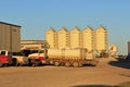 Fertilizer Bins with a tractor and truck at a plant north of Lyons Kansas.