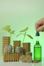 Fertilizer for seedlings. Seedling root system activator in a green glass bottle, a cucumber plant and a pipette in a