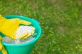 Fertilizing plants, lawns, trees and flowers. Gardener in gloves holds white fertilizer balls on grass