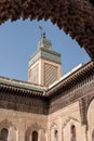 FES, MOROCCO - APRIL 01, 2023 - Traditional oriental facade at the courtyard of madrasa Bou Inaniya in the medina of Fes