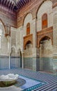 Ornate mosaic and carvings in a courtyard of a Moroccan medersa