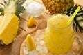 Feshly made pineapple slush on a wooden table elevated view Royalty Free Stock Photo