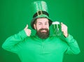 Fest and holiday menu. Dyed green traditional beer. Patricks day party. Alcohol beverage. Symbol of Ireland. Man bearded