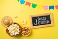 Festa Junina party background with popcorn, peanuts and chalkboard. Brazilian summer harvest festival concept. Top view, flat lay