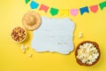 Festa Junina party background with popcorn, peanuts and wooden board. Brazilian summer harvest festival concept. Top view, flat