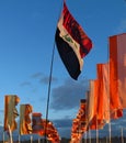 Festival flags waving in twilight against dramatic sky