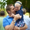 Festival fun with father and son. a father hugging his little boy at an outdoor festival. Royalty Free Stock Photo