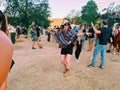 Festival girl dances in her poncho at doof