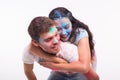 Festival of holi, friendship - young people playing with colors at the festival of holi on white background Royalty Free Stock Photo