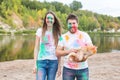 Festival holi, holidays, tourism and nature concept - Couple dressed in white shirts holding cat and covered with Royalty Free Stock Photo