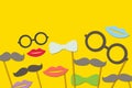 The festival mustache consists of a glasses, bow, lips isolated on yellow background Royalty Free Stock Photo
