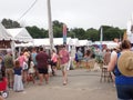 festival partakers meandering about.. vendors for food, shopping, tarot,