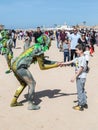 A festival participant dedicated to Purim dressed in a fairy-tale suit greets the visitor in Caesarea, Israel