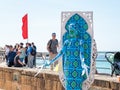 A festival participant dedicated to Purim stands dressed in a fairy statue costume in Caesarea, Israel