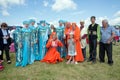 Festival participants in Russian and Tatar folk costumes stand in a clearing at the Karatag music festival. Royalty Free Stock Photo