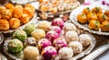 Festival sweets like laddoos, burfis, and ladoos on a silver tray . Royalty Free Stock Photo