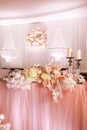 festival wedding table decoration with crystal chandeliers, golden candlestick, candles and white pink flowers and pink Royalty Free Stock Photo