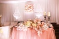 festival wedding table decoration with crystal chandeliers, golden candlestick, candles and white pink flowers and pink Royalty Free Stock Photo