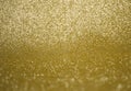 Festive abstract bright glitter gold background with blurred bokeh lights. Golden texture. Royalty Free Stock Photo