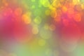 A festive abstract gradient green red orange yellow background texture with glitter defocused sparkle bokeh circles. Card concept Royalty Free Stock Photo