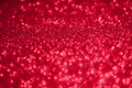 Festive abstract red glitter texture background with shiny sparkle. Colorful defocused background with glittering and sparkling Royalty Free Stock Photo