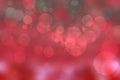 A festive abstract red Happy New Year or Christmas texture background and with color blurred bokeh lights and stars. Space for