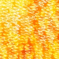 Festive abstract textured background. White curlicues on a yellow and orange background. Swirl pattern. Christmas lights Royalty Free Stock Photo