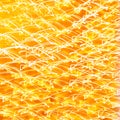 Festive abstract textured background. White curlicues on a yellow and orange background. Swirl pattern. Christmas lights Royalty Free Stock Photo