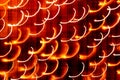 Festive abstract textured background. White and yellow curlicues on orange background. Swirl pattern. Christmas lights Royalty Free Stock Photo