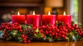 festive Advent arrangement with four lit red candles amidst holly berries and pinecones, all set against a warm, blurred Royalty Free Stock Photo