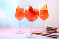 Festive alcoholic cocktail Aperol spritz in glasses on a bright background, concept for bar and New Year\'s Eve, alcoholic