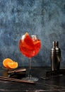 Festive alcoholic cocktail Aperol spritz in glasses on a dark background, concept for bar and New Year\'s Eve, alcoholic