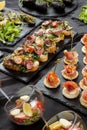 Festive appetizer. A set of bruschetta with roasted beef, cherry tomatoes and grated cheese, as well as toasted canapes Royalty Free Stock Photo