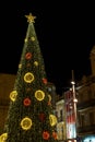Festive architecture with illuminated Christmas tree and decoration. Badalona, Spain
