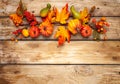 Festive autumn decor from pumpkins, berries and leaves on a rustic wooden background. Concept of Thanksgiving day or Halloween.