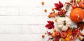 Festive autumn decor from pumpkins, berries and leaves on a white  wooden background. Concept of Thanksgiving day or Halloween. Royalty Free Stock Photo