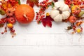 Festive autumn decor from pumpkins, berries and leaves on a white wooden background. Concept of Thanksgiving day or Halloween.
