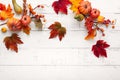Festive autumn decor from pumpkins, berries and leaves on a white  wooden background. Concept of Thanksgiving day or Halloween. Royalty Free Stock Photo