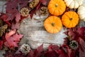 Festive autumn decor from pumpkins, pine and leaves on a wooden background. Concept of Thanksgiving day or Halloween. Flat lay