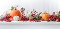 Festive autumn decorations of pumpkins, berries and leaves on a white wooden background. Thanksgiving or Halloween day concept. Royalty Free Stock Photo