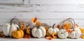 Festive autumn decorations of pumpkins, berries and leaves on a white wooden background. Thanksgiving or Halloween day concept. Royalty Free Stock Photo