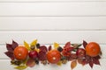Festive autumn flat lay with pumpkins, berries and leaves on wooden background, top view Royalty Free Stock Photo