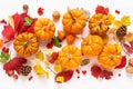 Festive autumn pumpkins decor with fall leaves, berries, nuts on white background. Thanksgiving day or halloween holiday, harvest Royalty Free Stock Photo