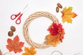 Festive autumn wreath with fall red and orange leaves on light background Royalty Free Stock Photo