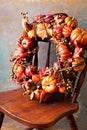 Festive autumn wreath with pumpkin and fall leaves Royalty Free Stock Photo